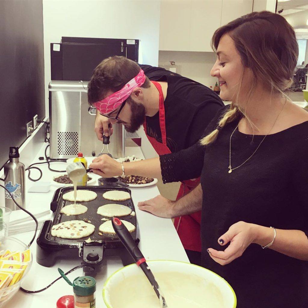 Conductor employees volunteering to make flapjacks to raise money for a charity of their choice.